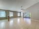 Open living room with vaulted ceiling, fan, and sliding glass doors to the lanai at 12938 Maribou Cir, Orlando, FL 32828