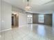 Spacious living room with tile floors, chandelier, and natural light from a large window at 12938 Maribou Cir, Orlando, FL 32828