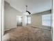 Spacious bedroom with carpet flooring, windows, and a ceiling fan at 12938 Maribou Cir, Orlando, FL 32828