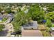 An aerial view highlights the property's backyard, pond, landscaping, and neighborhood streets at 1358 Brookebridge Dr, Orlando, FL 32825