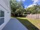 Large backyard with wooden fence, ample grass, and mature trees perfect for outdoor activities at 1358 Brookebridge Dr, Orlando, FL 32825