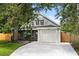 Charming home featuring grey siding, a one-car garage and mature trees for shade at 1358 Brookebridge Dr, Orlando, FL 32825