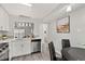 Kitchen area featuring stainless steel appliances, white cabinets, view to living room and dining table at 1358 Brookebridge Dr, Orlando, FL 32825