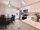 Bright kitchen area featuring stainless steel appliances, white cabinets, and dining table at 1358 Brookebridge Dr, Orlando, FL 32825