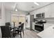 Bright kitchen area featuring stainless steel appliances, white cabinets, and dining table at 1358 Brookebridge Dr, Orlando, FL 32825