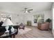 Bright living room featuring wood-look floors, modern ceiling fan and large windows at 1358 Brookebridge Dr, Orlando, FL 32825