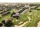 An aerial view of a resort community featuring a golf course, clubhouse, pool, and well-manicured landscaping at 1409 Bellamy Dr, Reunion, FL 34747