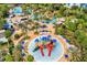 Aerial view of the resort featuring a water park, playgrounds, pools and palm trees at 1409 Bellamy Dr, Reunion, FL 34747