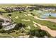 Expansive aerial view showcasing the community golf course and pool near residences at 1409 Bellamy Dr, Reunion, FL 34747