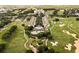 Breathtaking aerial view of a resort community with a golf course, pool, and manicured landscaping at 1409 Bellamy Dr, Reunion, FL 34747