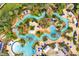 Aerial view of the resort featuring lazy rivers, pools, spas, palm trees, and landscaping at 1409 Bellamy Dr, Reunion, FL 34747