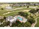 Stunning aerial view of a resort with a pool, golf course, and beautifully landscaped grounds at 1409 Bellamy Dr, Reunion, FL 34747