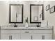 Bathroom with double sink vanity featuring modern lighting and decorative accents at 1409 Bellamy Dr, Reunion, FL 34747