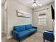 Bedroom featuring a comfortable sofa, ceiling fan, and a window providing natural light at 1409 Bellamy Dr, Reunion, FL 34747