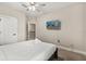 This bedroom features a plush bed, a ceiling fan, and a mounted TV for optimal entertainment and comfort at 1409 Bellamy Dr, Reunion, FL 34747