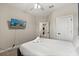 Bright bedroom with a queen bed, ceiling fan, and mounted TV, offering both comfort and entertainment at 1409 Bellamy Dr, Reunion, FL 34747