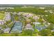 Aerial view of a residential community with pools, tennis courts, and manicured landscaping, providing a vibrant lifestyle at 1409 Bellamy Dr, Reunion, FL 34747