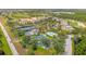 Aerial view of a residential community featuring tennis courts, swimming pools, and green spaces, promoting active living at 1409 Bellamy Dr, Reunion, FL 34747