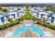 Aerial view of community pools with modern lounge areas, surrounded by lush greenery, creating a resort-style experience at 1409 Bellamy Dr, Reunion, FL 34747