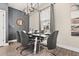 Dining room with a modern glass table, stylish chairs, contemporary lighting, and large window, perfect for entertaining at 1409 Bellamy Dr, Reunion, FL 34747