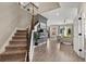 Open-concept living with a staircase, wood floors, and an open view of the living room with ample natural light at 1409 Bellamy Dr, Reunion, FL 34747