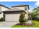 Charming two-story home with a well-manicured lawn and a two-car garage, offering a welcoming curb appeal at 1409 Bellamy Dr, Reunion, FL 34747