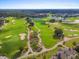 Lush golf course featuring mature trees, water features, and manicured fairways creating a scenic and challenging course at 1409 Bellamy Dr, Reunion, FL 34747
