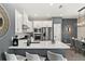 Stylish kitchen featuring a quartz countertop island, white cabinetry, stainless steel appliances, and hardwood flooring at 1409 Bellamy Dr, Reunion, FL 34747