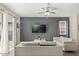 Bright living room featuring modern white furniture, a ceiling fan, and a sliding glass door to the outside at 1409 Bellamy Dr, Reunion, FL 34747