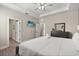 Spacious main bedroom featuring a queen-sized bed, ceiling fan, and an ensuite bathroom at 1409 Bellamy Dr, Reunion, FL 34747