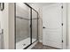 Modern tiled shower featuring a glass enclosure, built-in shelving, and modern fixtures at 1409 Bellamy Dr, Reunion, FL 34747