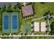 Aerial view featuring tennis, sand volleyball, and basketball courts, offering various recreational activities within the community at 1409 Bellamy Dr, Reunion, FL 34747
