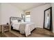 Clean bedroom featuring neutral walls, wood-look flooring, and decoratively leaning floor mirror at 165 Lavenna Ave, St Cloud, FL 34771