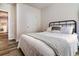 Bedroom featuring wood-look flooring, neutral walls, full bed, and view into hall at 165 Lavenna Ave, St Cloud, FL 34771
