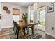 Bright dining area with wood table, stylish rug, and sliding door to backyard patio at 165 Lavenna Ave, St Cloud, FL 34771