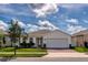 Charming single-story home with brick driveway, lush landscaping, and a two-car garage at 165 Lavenna Ave, St Cloud, FL 34771