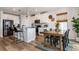 Open kitchen and dining area with stainless steel appliances and modern decor create a cozy space at 165 Lavenna Ave, St Cloud, FL 34771