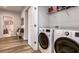 Laundry room with modern washer and dryer, shelf space, and doorway into bathroom at 165 Lavenna Ave, St Cloud, FL 34771