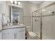 Bright bathroom featuring a vanity with stone countertop and walk-in shower with glass door at 17551 Black Rail St, Windermere, FL 34786