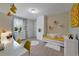Bright bedroom featuring built-in shelves, desk, daybed with plush pillows, and a window view at 17551 Black Rail St, Windermere, FL 34786