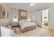 This stylish bedroom features a modern bed frame, trendy lamps, and a sliding door to the bathroom at 17551 Black Rail St, Windermere, FL 34786