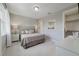 A calming bedroom features a neutral color palette, soft carpet, and cozy bedding at 17551 Black Rail St, Windermere, FL 34786