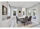 Dining room with a contemporary chandelier, natural light, and gray chairs around a white table at 17551 Black Rail St, Windermere, FL 34786