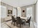 Dining room with marble floors, chandelier, and windows with light-filtering curtains at 17551 Black Rail St, Windermere, FL 34786
