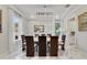 Dining room with marble floors, chandelier, and multiple windows at 17551 Black Rail St, Windermere, FL 34786