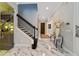 Elegant foyer featuring marble floors, staircase, and access to the bar at 17551 Black Rail St, Windermere, FL 34786