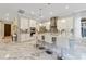 Modern kitchen featuring white cabinetry, stainless steel appliances, a large island, and marble floors at 17551 Black Rail St, Windermere, FL 34786