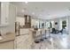 Bright eat-in kitchen with marble floors, stainless steel appliances, and a large center island with bar stool seating at 17551 Black Rail St, Windermere, FL 34786