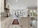 Bright, contemporary kitchen with marble floors, a large island, stainless appliances, and stylish pendant lighting at 17551 Black Rail St, Windermere, FL 34786
