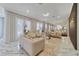 Airy living room with marble floors, stylish decor, elegant lighting, and a decorative wall enhanced by natural light at 17551 Black Rail St, Windermere, FL 34786